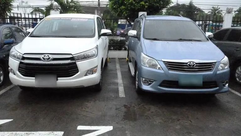 Two Toyota Innova cars parked side by side