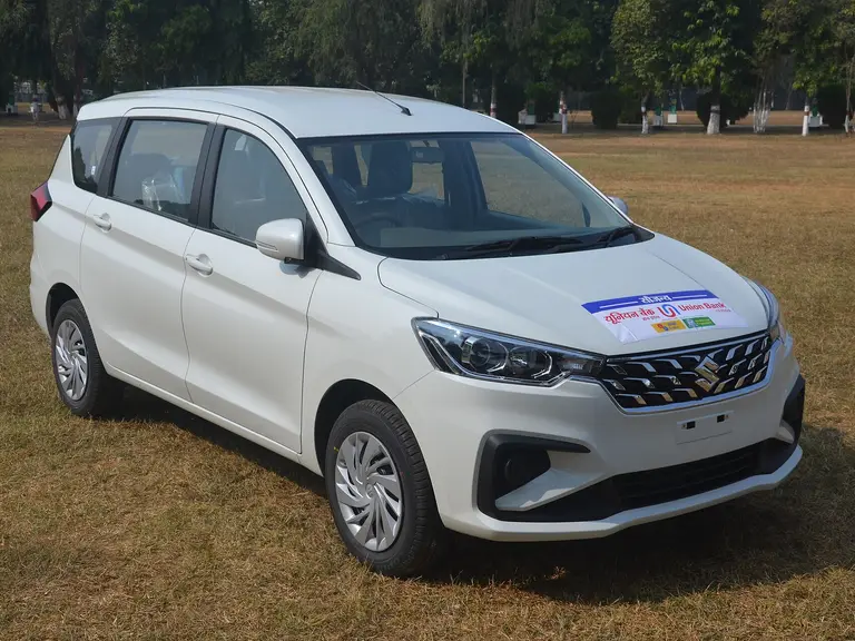 White Maruti Ertiga seven-seater on a lawn