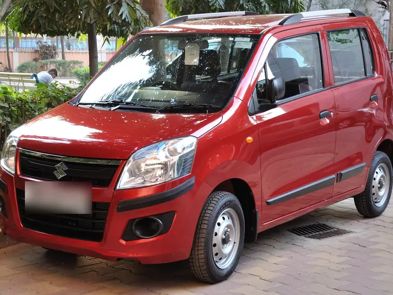 Red Maruti WagonR hatchback parked by the roadside