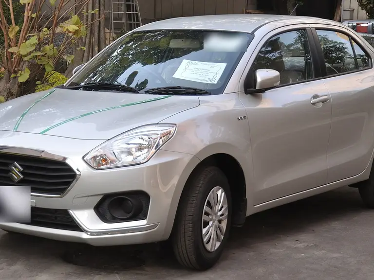 Silver Maruti Dzire sedan, front three-quarter view