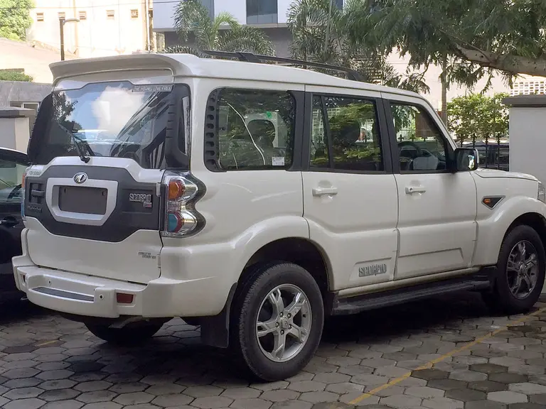 White Mahindra Scorpio SUV, side and rear view