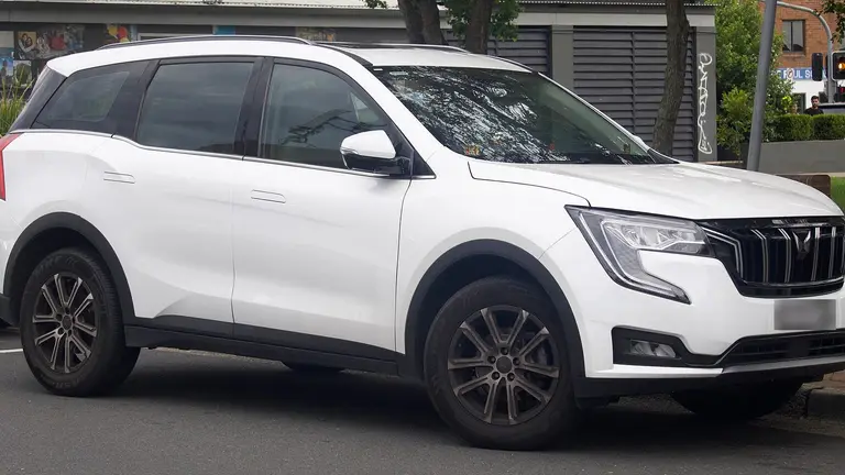 Clean white premium SUV parked on a quiet street